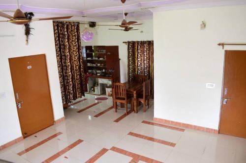 a living room with a table and a ceiling fan at Poonam Palace near by Airport in Jodhpur