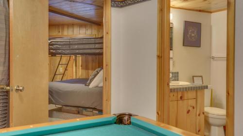 a bathroom with a pool table and a bunk bed at Cedar Creek Hideaway - Meredith Lodging in Welches
