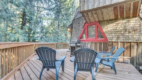 two chairs and a table on a deck at Cedar Creek Hideaway - Meredith Lodging in Welches