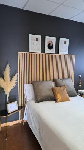 a bedroom with a large bed with a wooden headboard at ERAS 3 in Herencia