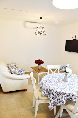 a living room with a table and a chair at R Cottage Jacuzzival in Balatonfenyves