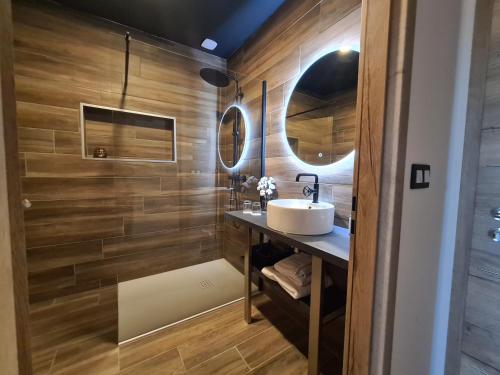 a bathroom with a sink and a mirror at La suite Mélusine - SPA du Souffle du Saule in Buhl-Lorraine