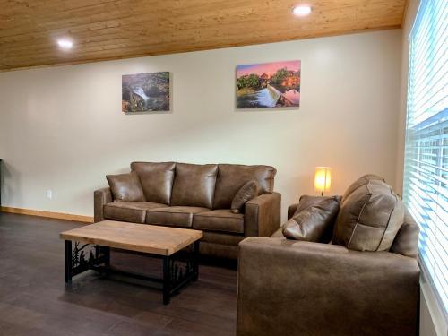 a living room with two couches and a coffee table at High Valley Apartments in Pigeon Forge