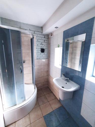 a bathroom with a shower and a sink and a toilet at Hostel Mamas & Papas in Gdańsk