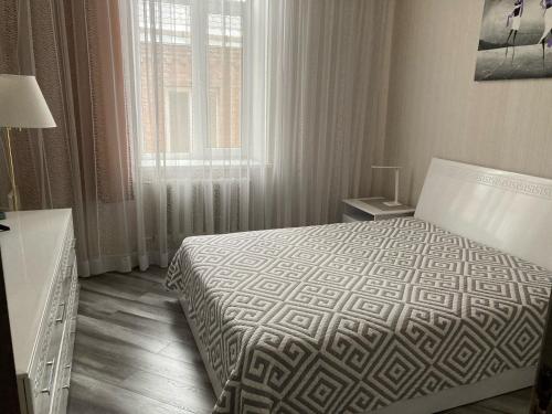 a hotel room with a bed and a window at Apartment Sobornaya 54 in Vinnytsya