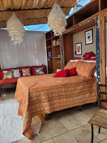 a bedroom with a bed with red pillows at Mansion Aline in Rio de Janeiro