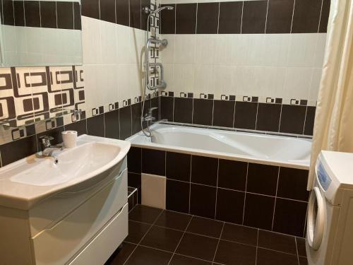 a bathroom with a sink and a bath tub at Apartment Sobornaya 54 in Vinnytsya