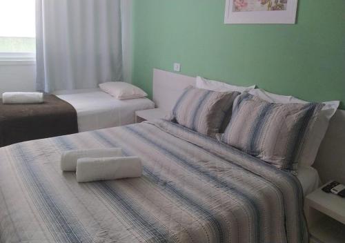 a bedroom with a bed with two pillows on it at Apart Hotel Praia dos Carneiros Apto 101 in Praia dos Carneiros