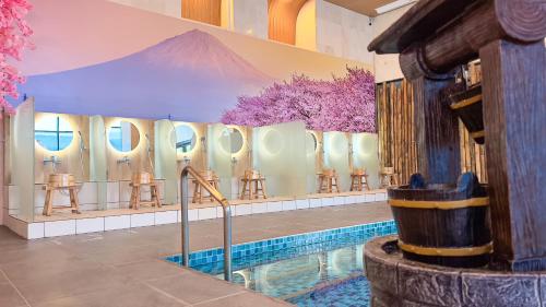 a bathroom with a pool and a row of mirrors at The Yanné, Onsen Hotel in Genting Highlands