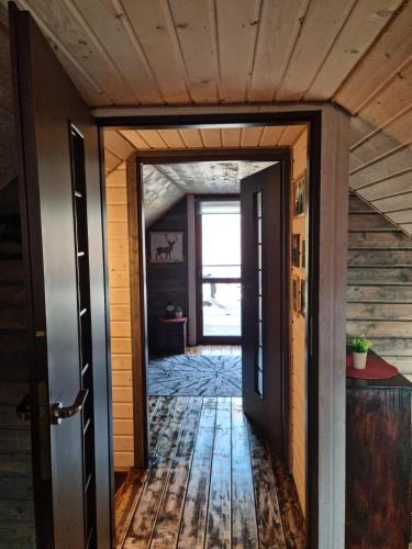 an open door leading to a hallway with wood floors at Ostoja Karkonoska in Podgórzyn