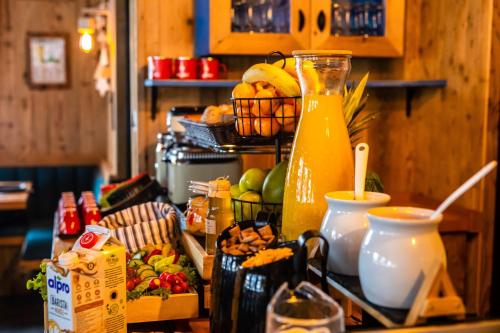 a counter with a blender and a bunch of food at KITZALPEN Pension in Hollersbach im Pinzgau