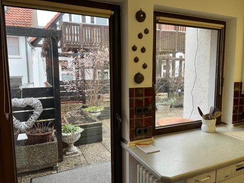 a kitchen with a window looking out at a courtyard at Altstadt-FeWo-Zentrum in Hameln
