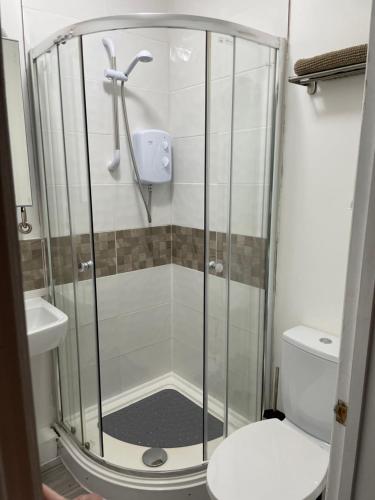 a shower stall in a bathroom with a toilet at A Room at The Oaks in Golden Valley