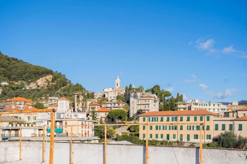 a cityscape of a city with buildings on a hill at 083 - Casa Grande con Attico condominiale vista mare, 500 metri dalla spiaggia in Chiavari