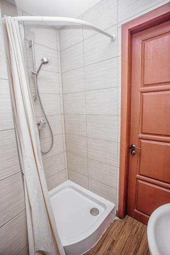 a bathroom with a shower and a toilet and a sink at Guest House "Arkhistratyg" in Lviv