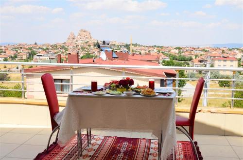 a table with a plate of food on a balcony at Castle Panorama House in Nevşehir