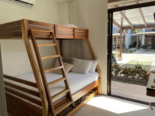 a bunk bed in a room with a window at Perfect combination between nature and fun in Jacó