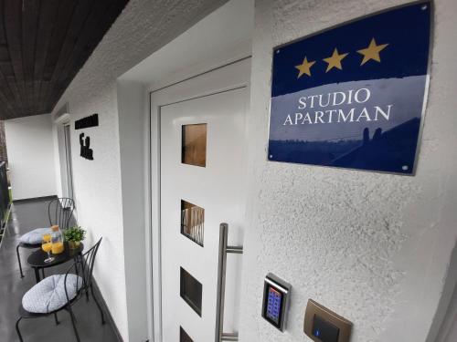 a door to a room with a flag on the wall at Tonka studio apartman in Križevci