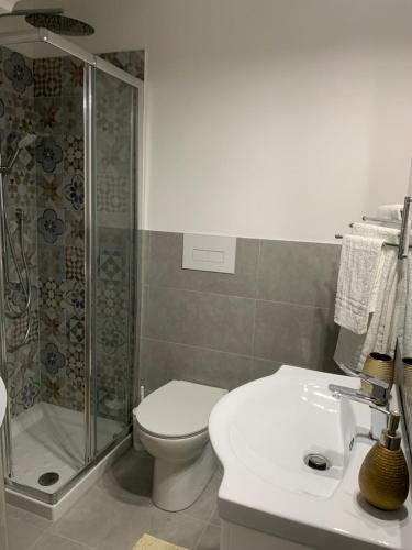 a bathroom with a shower and a toilet and a sink at B&B Ramura in Mazara del Vallo