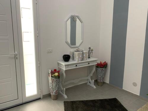 a bathroom with a white sink and a mirror at B&B Ramura in Mazara del Vallo