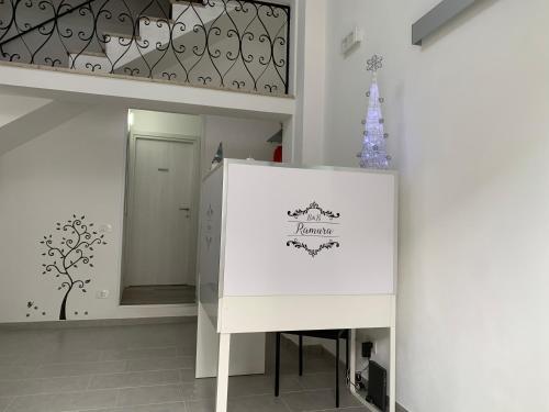 a room with a white table and a christmas tree at B&B Ramura in Mazara del Vallo