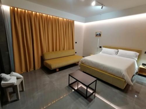 a hotel room with a bed and a couch at Hotel XBusiness in Nola