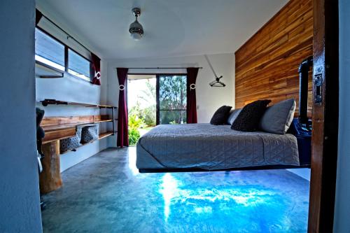 a bedroom with a bed and a pool in the floor at Casa Swell Coronado A unique blend of luxury and nature in the hearth of Coronado in Playa Coronado