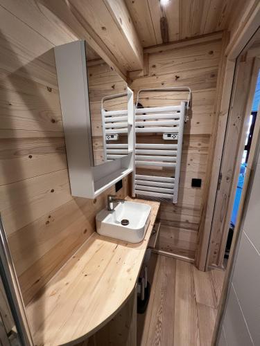 a bathroom with a sink in a tiny house at Les appartements de Makalu Val Thorens in Val Thorens