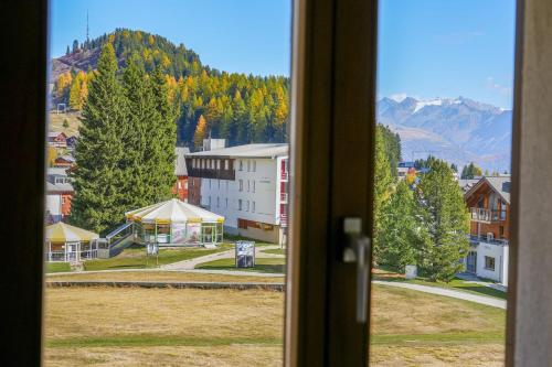 a view from a window of a town with mountains at Serenella Apartment in Riederalp