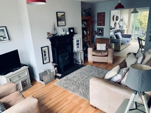 a living room with a couch and a fireplace at Ballycastle Holiday Home in Ballycastle