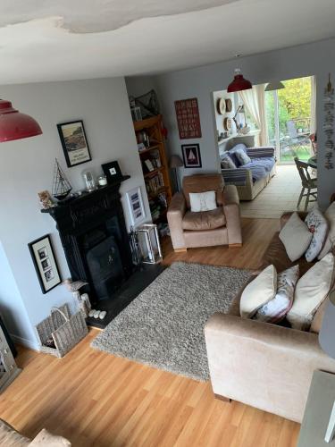 a living room with a couch and a fireplace at Ballycastle Holiday Home in Ballycastle