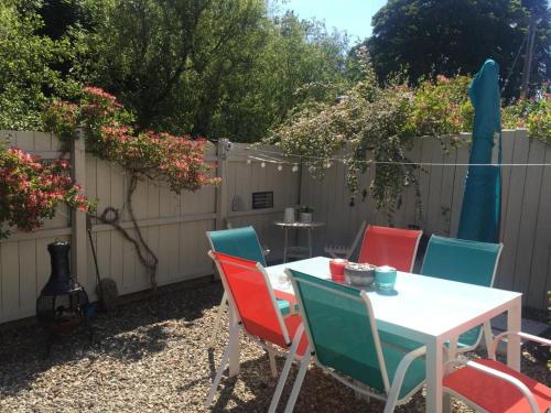 a table and chairs in a backyard with a fence at Ballycastle Holiday Home in Ballycastle
