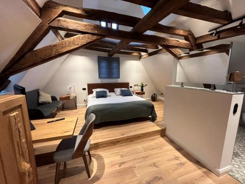 a bedroom with a bed in a room with wooden ceilings at Landgasthof zur Burg Grenzau in Höhr-Grenzhausen
