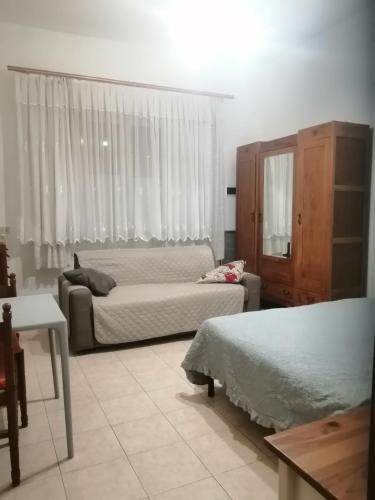a bedroom with two beds and a dresser in it at Casa Serena in Follonica