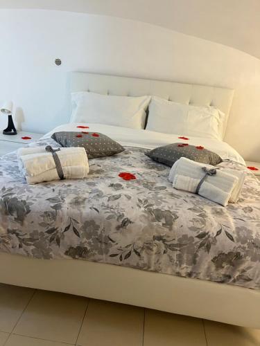 a large white bed with pillows on top of it at Petite Suite in Naples