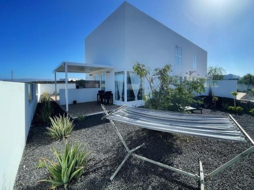 a hammock in front of a house at Azur Arts Lanzarote Lofts in Tinajo