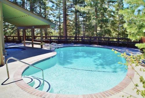 a large swimming pool with a gazebo at Cozy condo walking distance to village and gondola w/ pool/ jacuzzi sleeps 4. in Mammoth Lakes