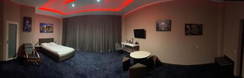 a hotel room with a bed and a tv at LEX Trend Hotel in Irpin'
