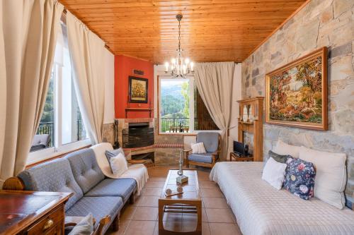 a living room with a couch and a fireplace at House Eufrosyne in Moutoullas