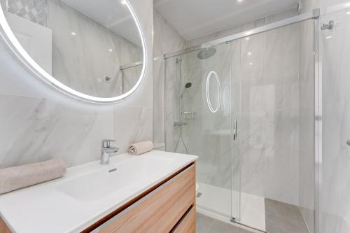 a bathroom with a shower and a sink and a mirror at LosCristianos Luxury AirCon Sunny Aptm Sea View in Arona