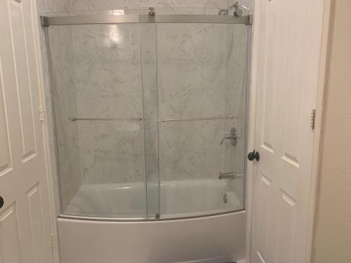 a bathroom with a shower with a glass door at LuxHome Suites in Mansion in Riverside