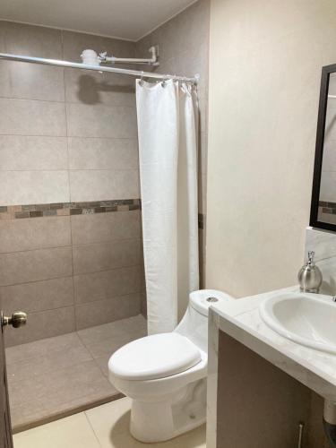 a bathroom with a toilet and a shower and a sink at Hospedaje Ana Lu 2, Only 10 minutes from airport in Alajuela City