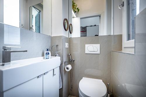 y baño con aseo blanco y lavamanos. en Relais Lavagnini Florence, en Florencia