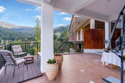 a house with a balcony with a view of the mountains at House Eufrosyne in Moutoullas