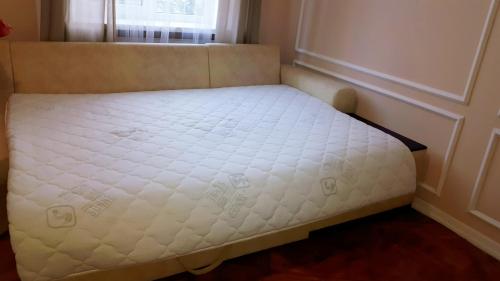 a small bed in a room with a window at Apartment in the city center in Ivano-Frankivsʼk