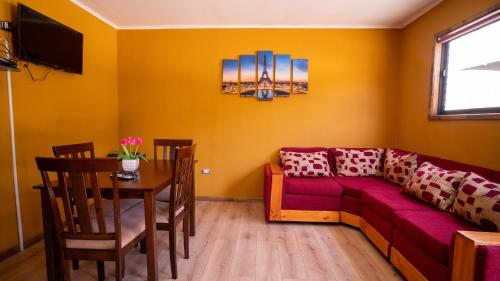 a living room with a couch and a table at cabañas laguna de zapallar maitencillo in Zapallar