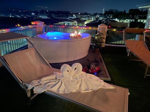 a towel sitting on a bench on a balcony at night at Argentiere Room Apartments in Florence