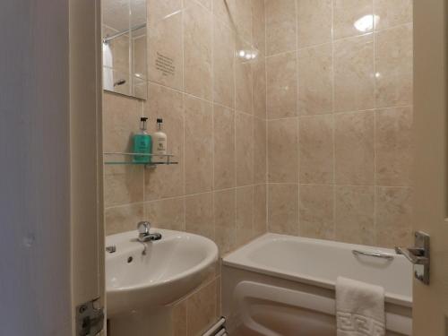 a bathroom with a white toilet and a sink at Marston Farm Hotel in Sutton Coldfield