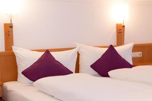 two purple pillows sitting on top of a bed at Hotel St. Nikolaus in Ischgl