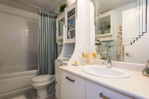 a bathroom with a sink and a toilet and a shower at Stunning condo with fantastic view of the city! in Toronto